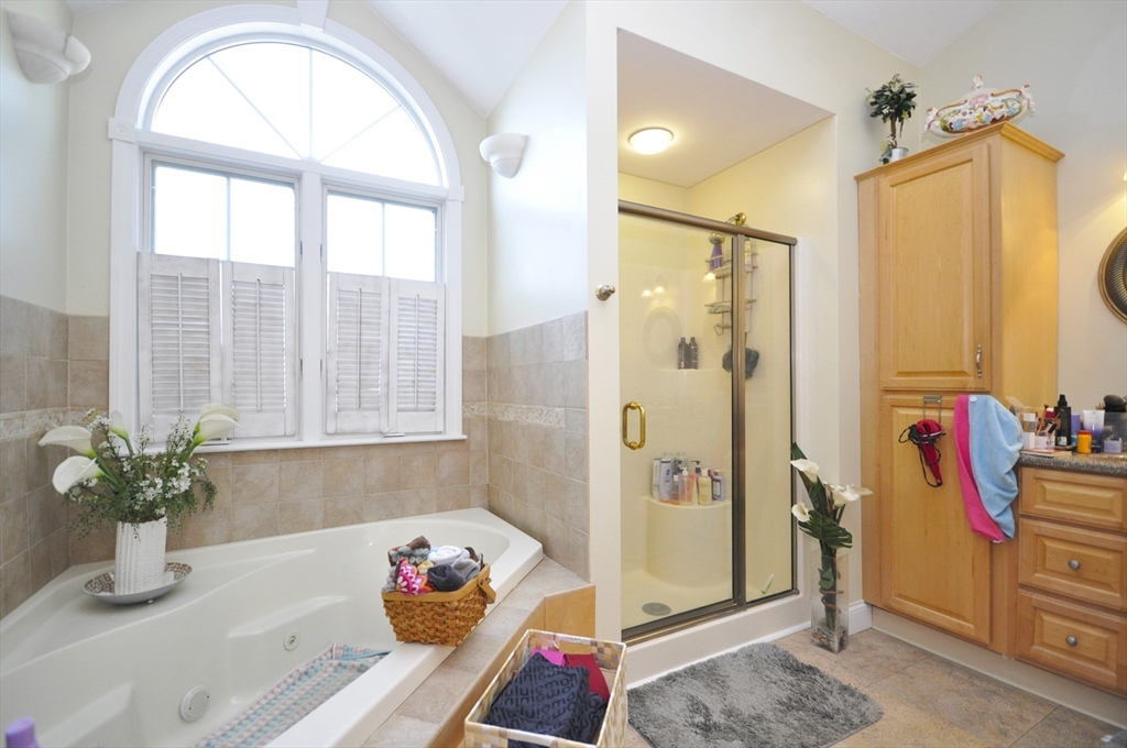413 Harvard Street Whitman, MA 02382 - Photo 18 of 42 a bathroom with a tub shower and a window