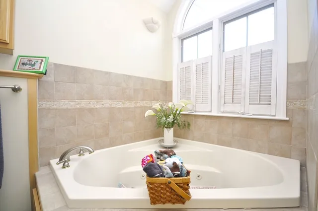 a bathroom with a granite countertop toilet sink and mirror