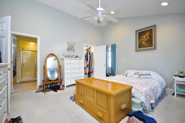 a bed room with bed and a chandelier