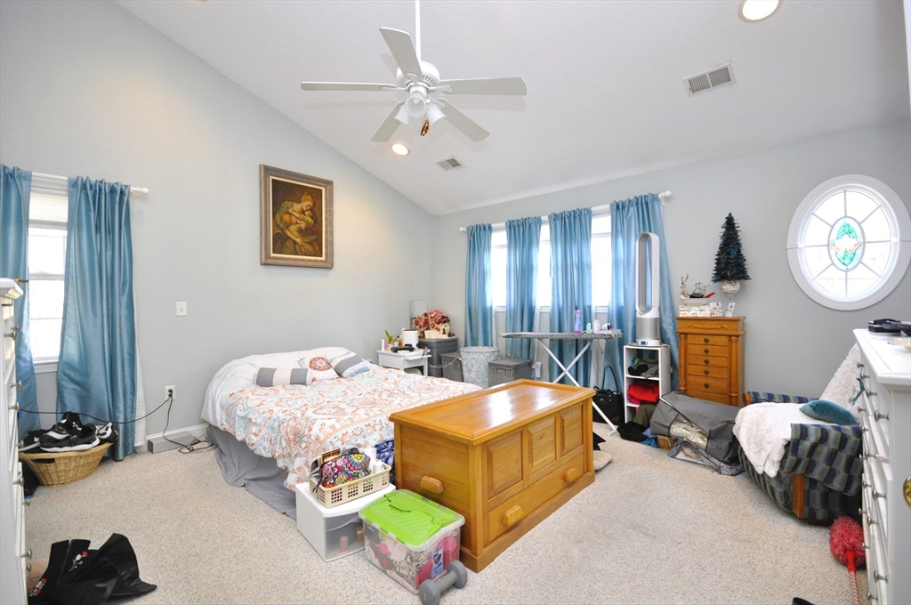 413 Harvard Street Whitman, MA 02382 - Photo 23 of 42 a bed room with bed and a chandelier