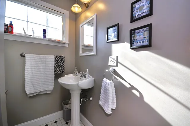 a bathroom with a sink a mirror and a shower