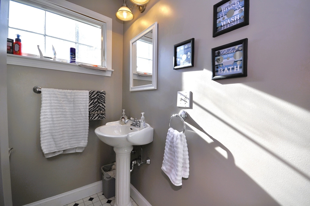 413 Harvard Street Whitman, MA 02382 - Photo 26 of 42 a bathroom with a sink and a mirror