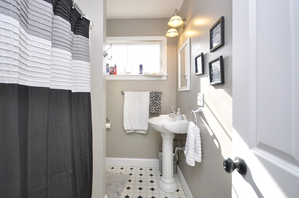 413 Harvard Street Whitman, MA 02382 - Photo 27 of 42 a bathroom with a sink a mirror and a shower