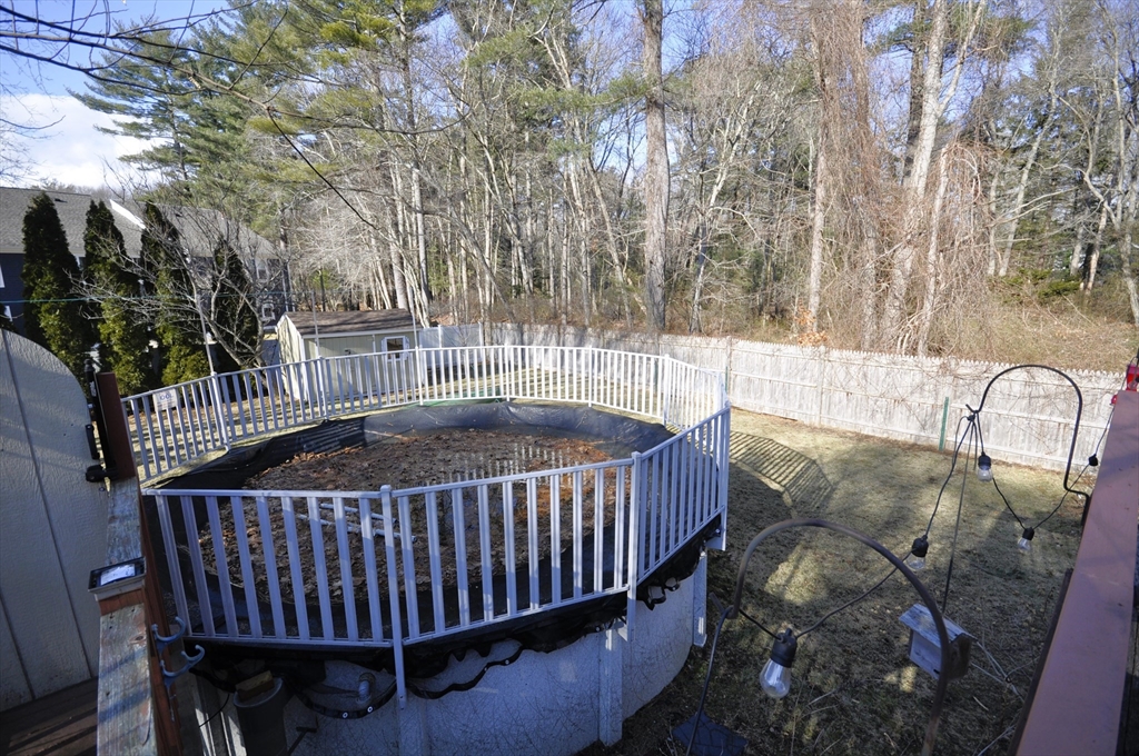413 Harvard Street Whitman, MA 02382 - Photo 32 of 42 a view of balcony with wooden fence
