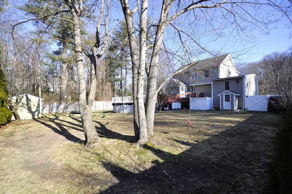 413 Harvard Street Whitman, MA 02382 - Photo 35 of 42 a view of a house with a yard covered in snow