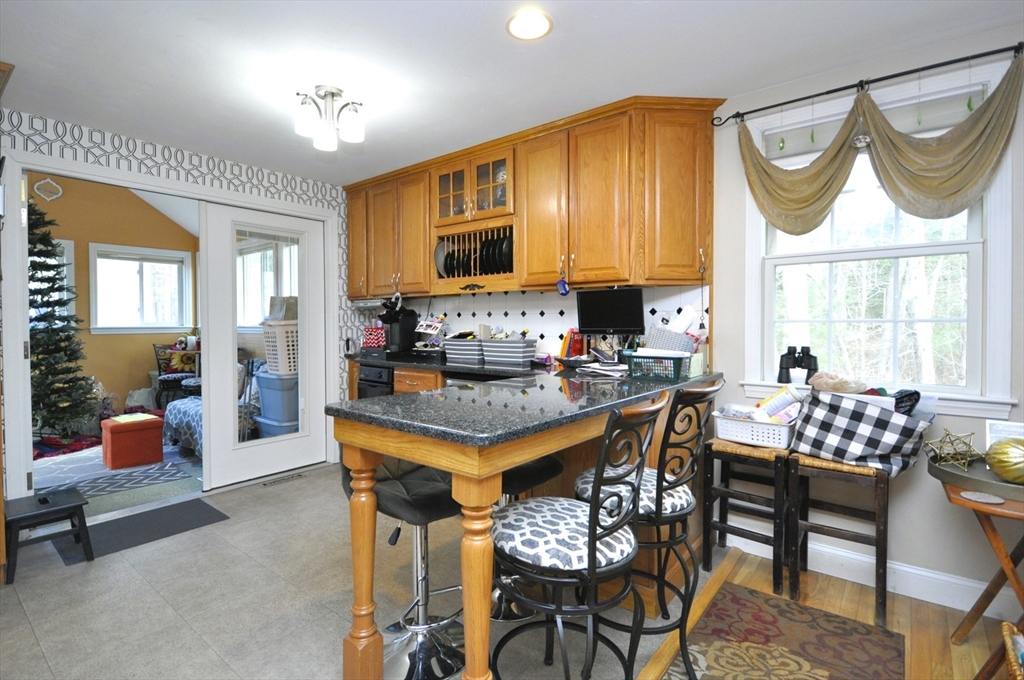 413 Harvard Street Whitman, MA 02382 - Photo 8 of 42 a kitchen with a dining table chairs and a refrigerator
