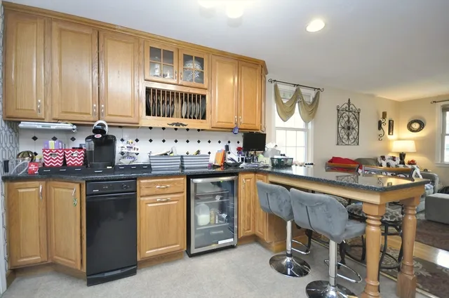a kitchen with a sink stove and white cabinets
