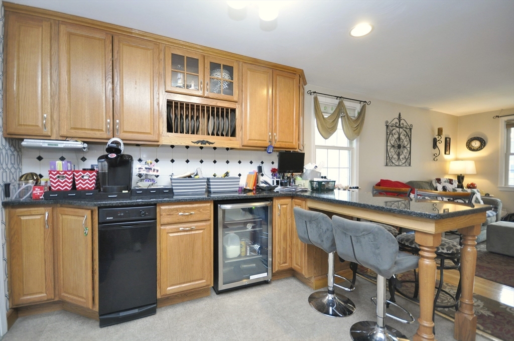413 Harvard Street Whitman, MA 02382 - Photo 9 of 42 a kitchen with a sink stove and white cabinets
