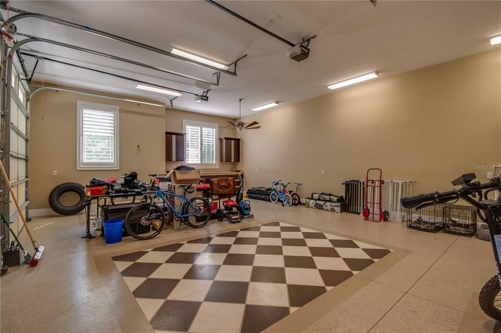 1219 Southwest 63rd Street Road Ocala, FL 34476 - Photo 11 of 72 a room with lots of white walls and black white checkered floor
