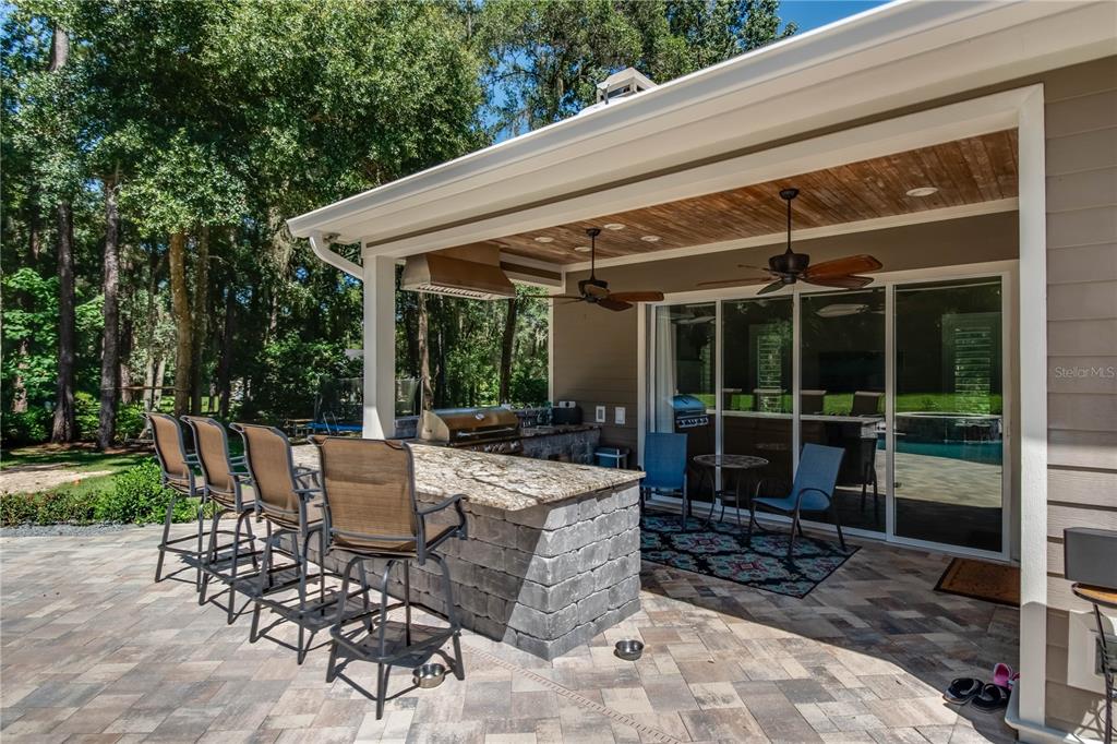 1219 Southwest 63rd Street Road Ocala, FL 34476 - Photo 14 of 72 a view of a patio with table and chairs potted plants and floor to ceiling window