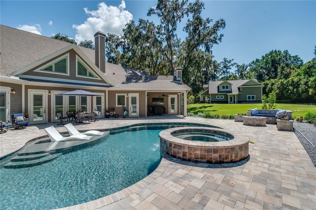 1219 Southwest 63rd Street Road Ocala, FL 34476 - Photo 16 of 72 a view of a house with backyard sitting area and garden