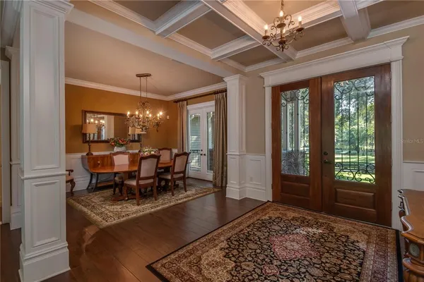 a view of a dining room with furniture wooden floor and chandelier