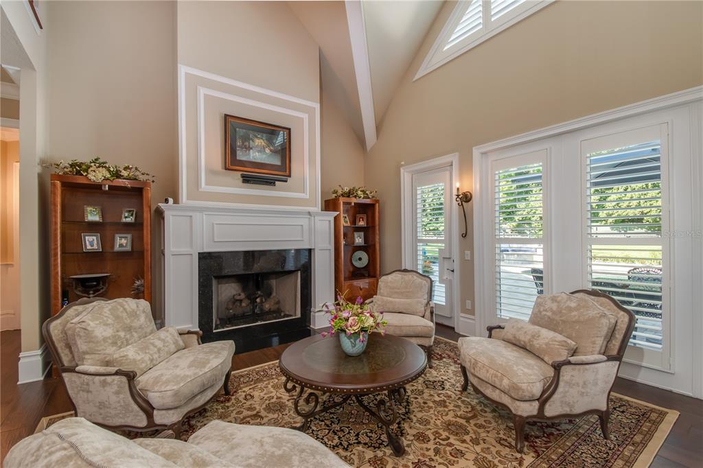 1219 Southwest 63rd Street Road Ocala, FL 34476 - Photo 25 of 72 a living room with furniture a fireplace and a large window