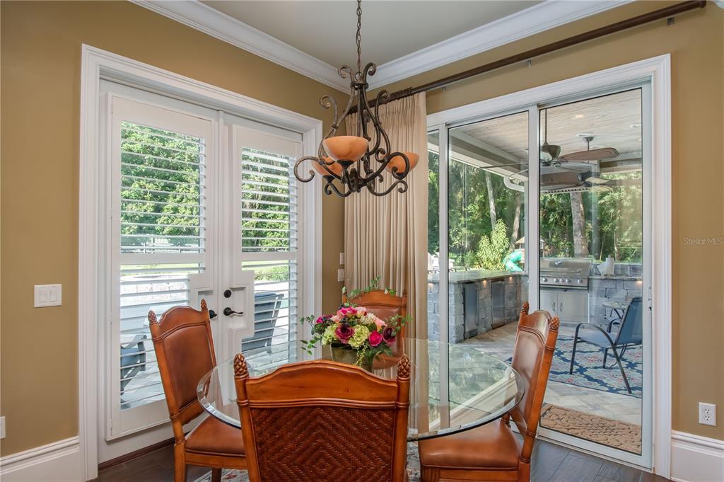 1219 Southwest 63rd Street Road Ocala, FL 34476 - Photo 28 of 72 a view of a dining room with furniture wooden floor and chandelier