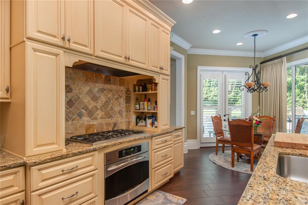 1219 Southwest 63rd Street Road Ocala, FL 34476 - Photo 30 of 72 a kitchen with stainless steel appliances granite countertop a stove and a refrigerator