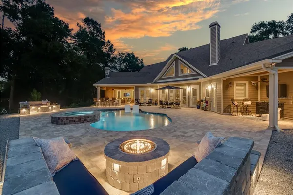 swimming pool view with a seating space