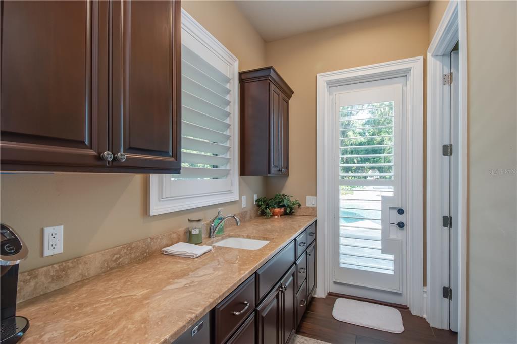 1219 Southwest 63rd Street Road Ocala, FL 34476 - Photo 41 of 72 a bathroom with a granite countertop sink and a mirror
