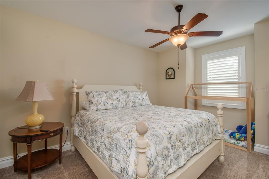 1219 Southwest 63rd Street Road Ocala, FL 34476 - Photo 45 of 72 a bedroom with a bed and a chandelier