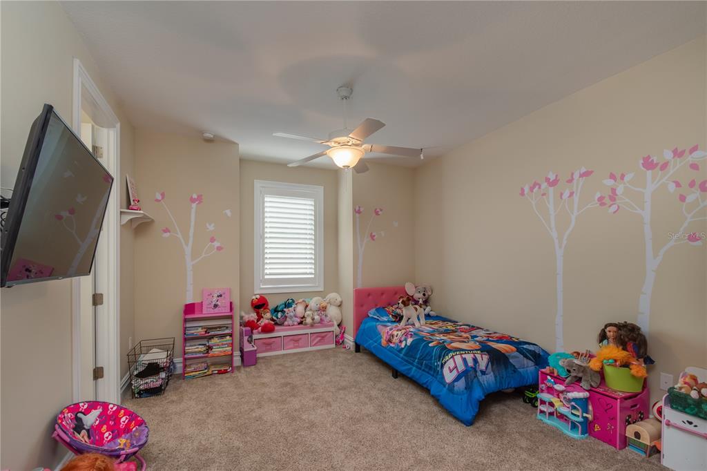 1219 Southwest 63rd Street Road Ocala, FL 34476 - Photo 48 of 72 a bedroom with a bed and a chandelier