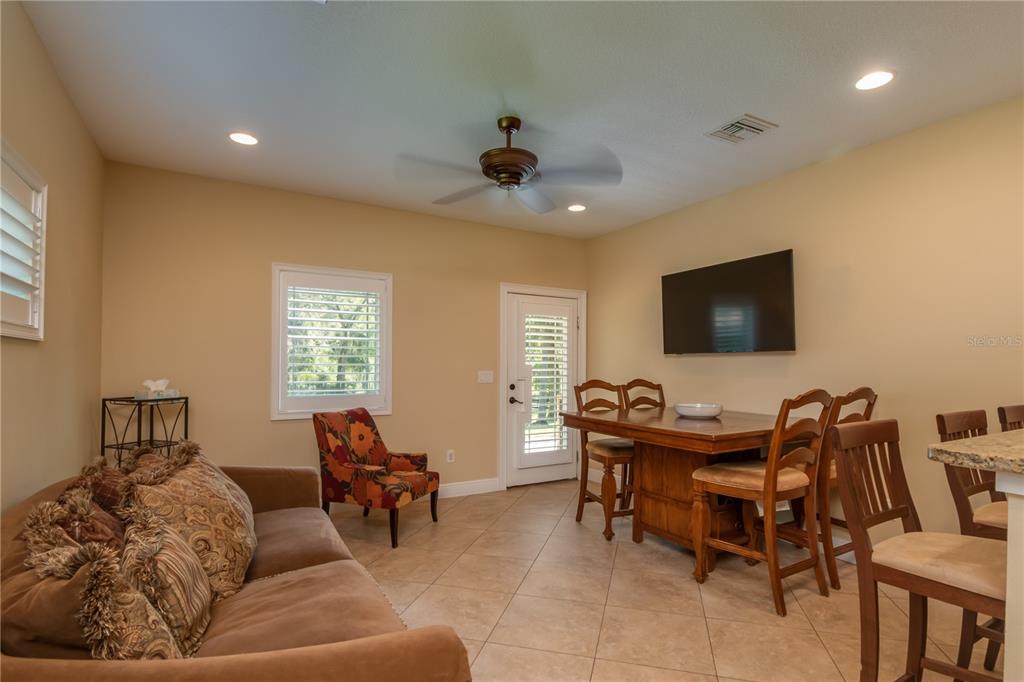 1219 Southwest 63rd Street Road Ocala, FL 34476 - Photo 55 of 72 a living room with furniture and a flat screen tv