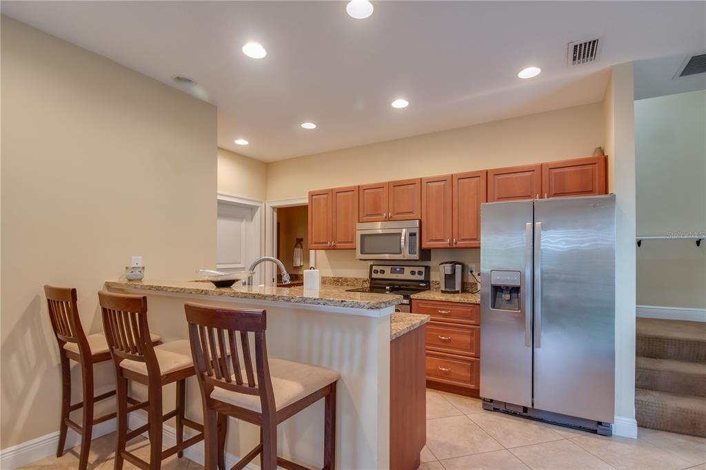 1219 Southwest 63rd Street Road Ocala, FL 34476 - Photo 56 of 72 a kitchen with kitchen island a counter top space appliances and cabinets