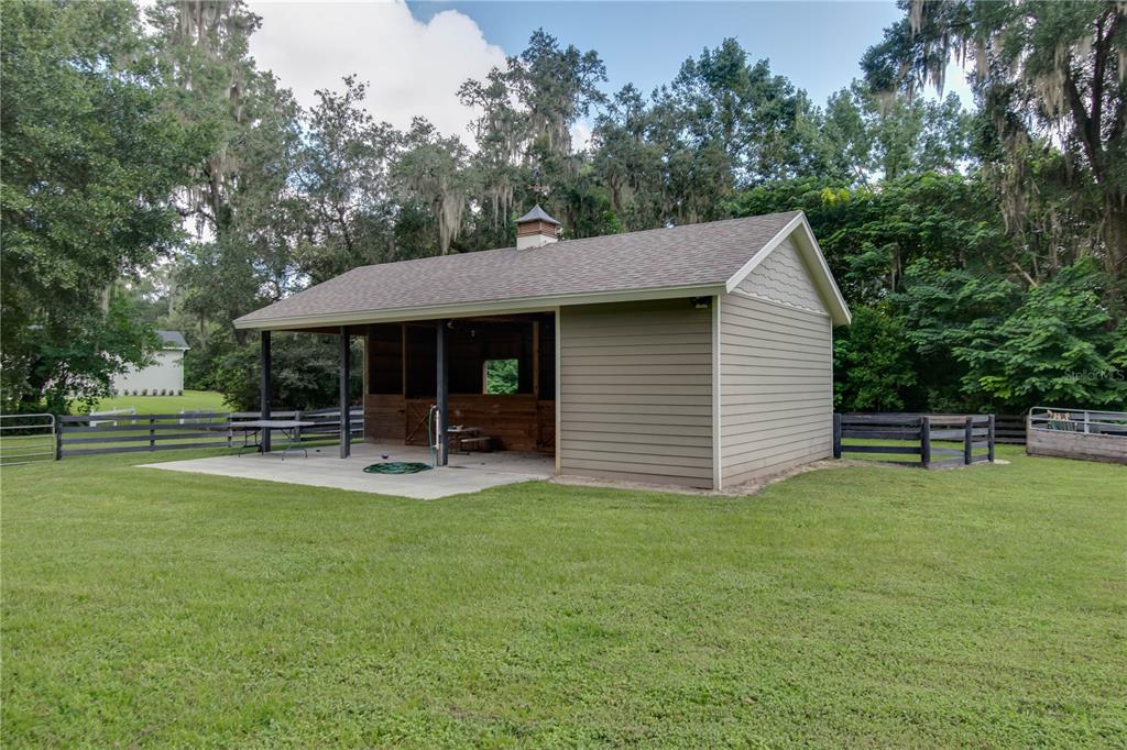 1219 Southwest 63rd Street Road Ocala, FL 34476 - Photo 61 of 72 a view of a house with backyard porch and sitting area