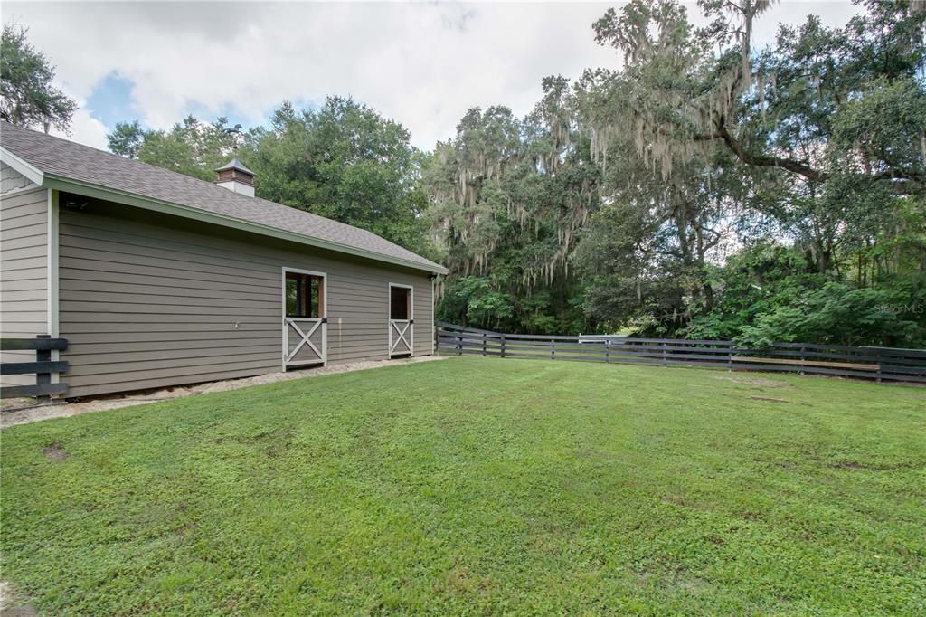 1219 Southwest 63rd Street Road Ocala, FL 34476 - Photo 63 of 72 a view of a backyard with large trees