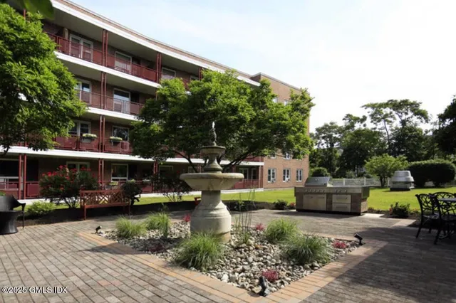 a view of swimming pool with outdoor seating and a potted plant