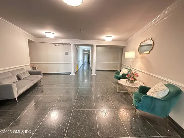 a lobby with furniture and a rug