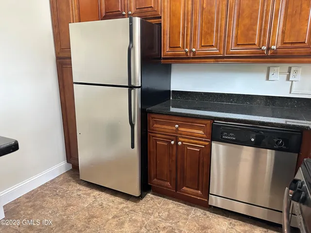 a white refrigerator freezer sitting inside of a kitchen