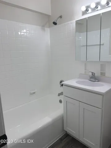 a bathroom with a sink a shower and a mirror