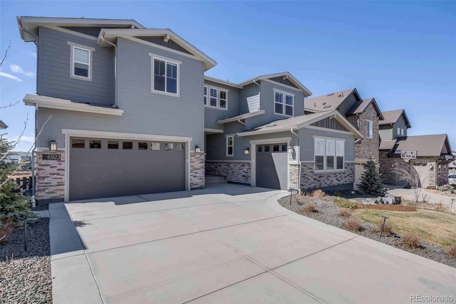 6923 Copper Sky Circle Castle Pines, CO 80108 - Photo 1 of 1 a front view of a house with a yard