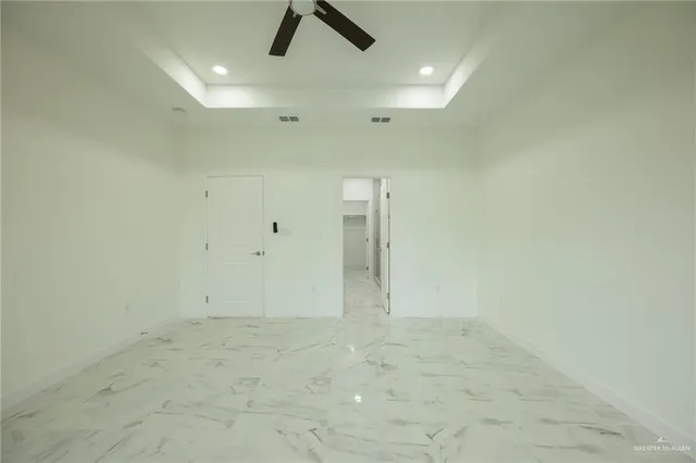 a view of a livingroom with a ceiling fan and window
