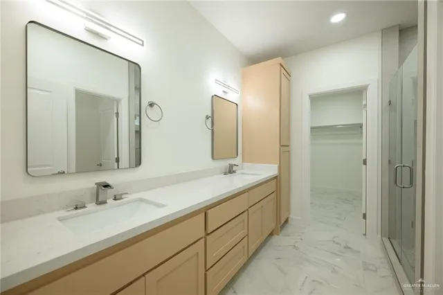 a bathroom with a granite countertop sink mirror and double