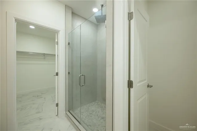 a bathroom with a shower and a sink