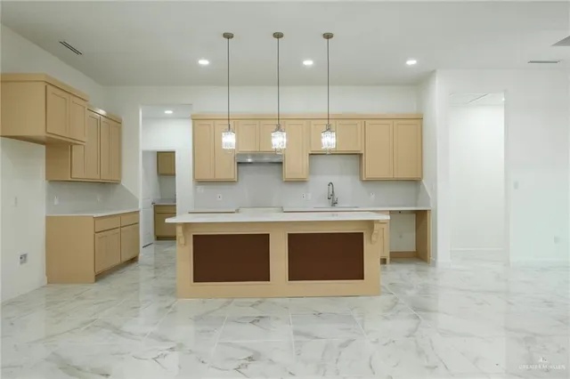 a large kitchen with a stove a sink and a microwave