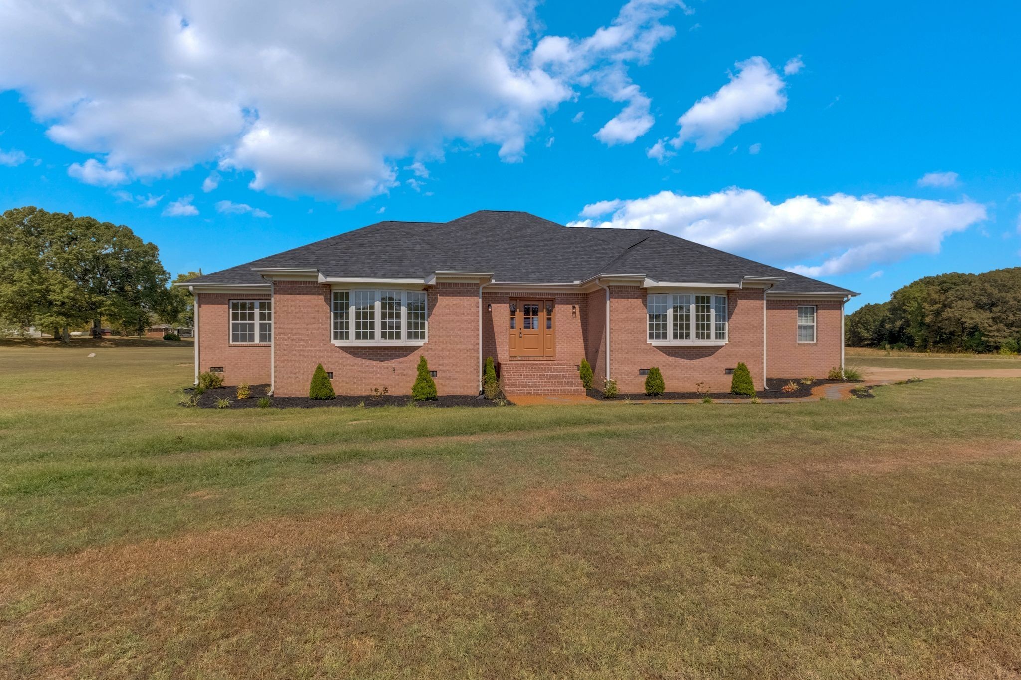 a front view of a house with a garden