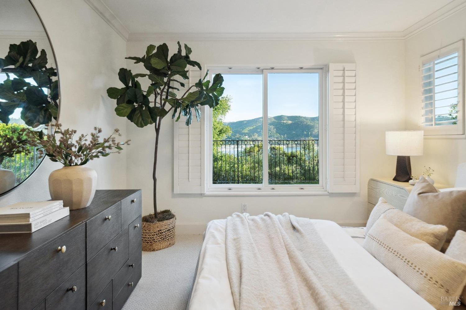 113 Chapel Drive Mill Valley, CA 94941 - Photo 51 of 60 a bed sitting in a bedroom next to a window with potted plant