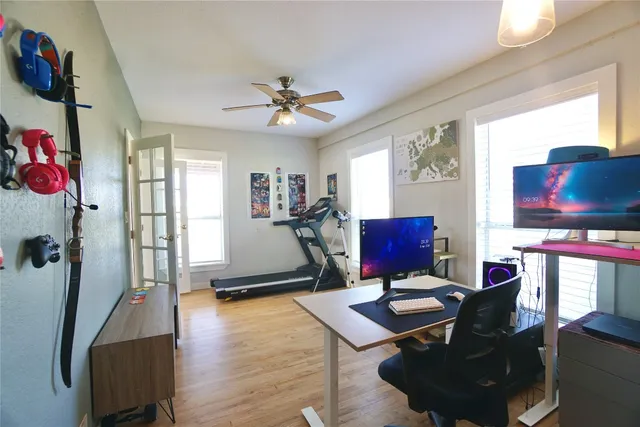 a view of a workspace with furniture and a window