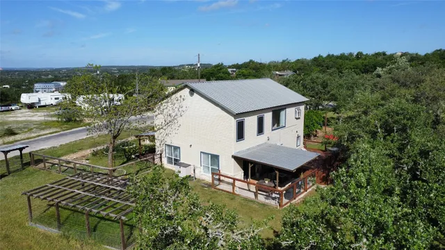 a view of house with backyard and deck