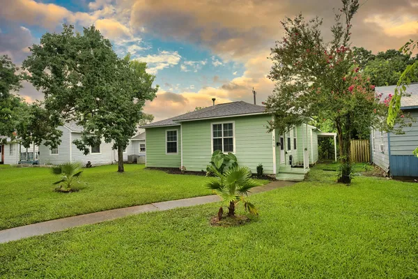 a house view with a sitting space and garden