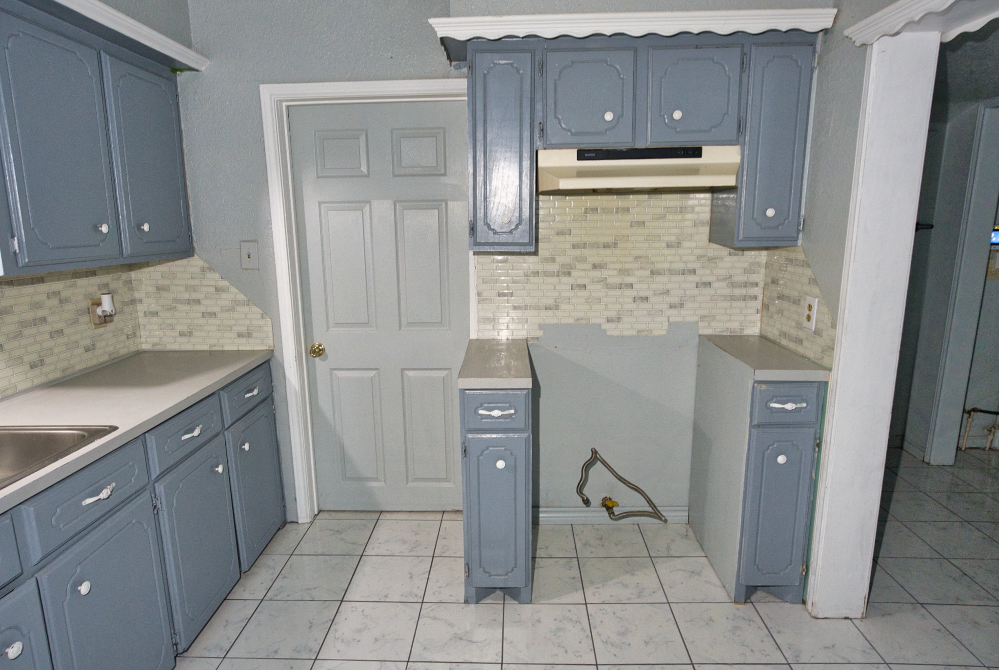 1619 West 8th Street Freeport, TX 77541 - Photo 10 of 35 Freshly painted cabinets and walls with and new tile floor and backsplash