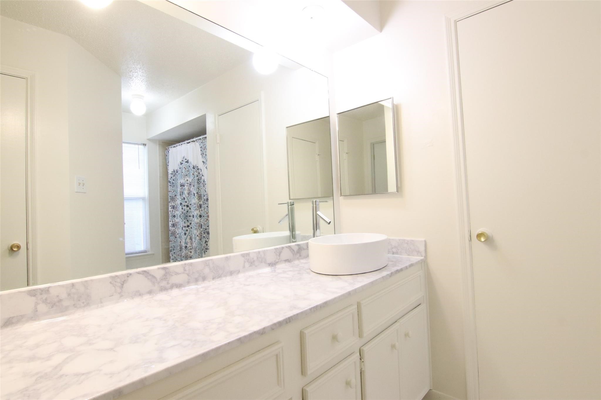 4231 Yupon Ridge Drive Houston, TX 77072 - Photo 12 of 18 a bathroom with a sink and a mirror