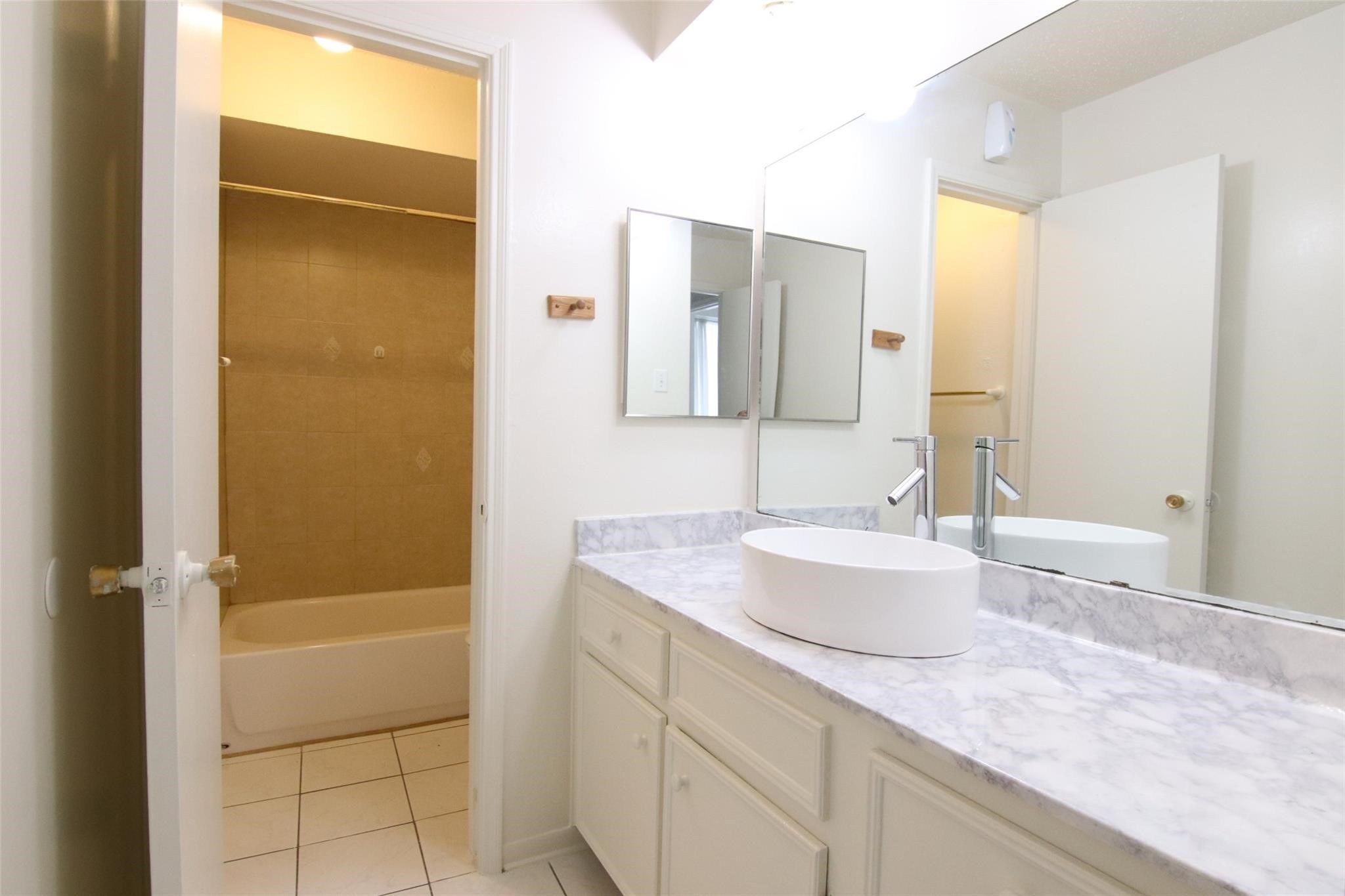 4231 Yupon Ridge Drive Houston, TX 77072 - Photo 15 of 18 a bathroom with a granite countertop sink a mirror and a bathtub
