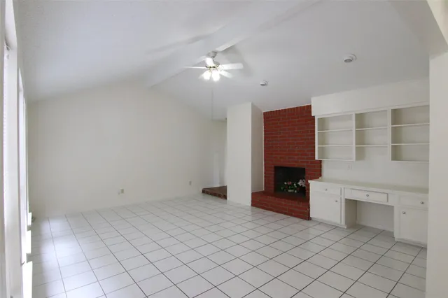 a view of an empty room with a fireplace