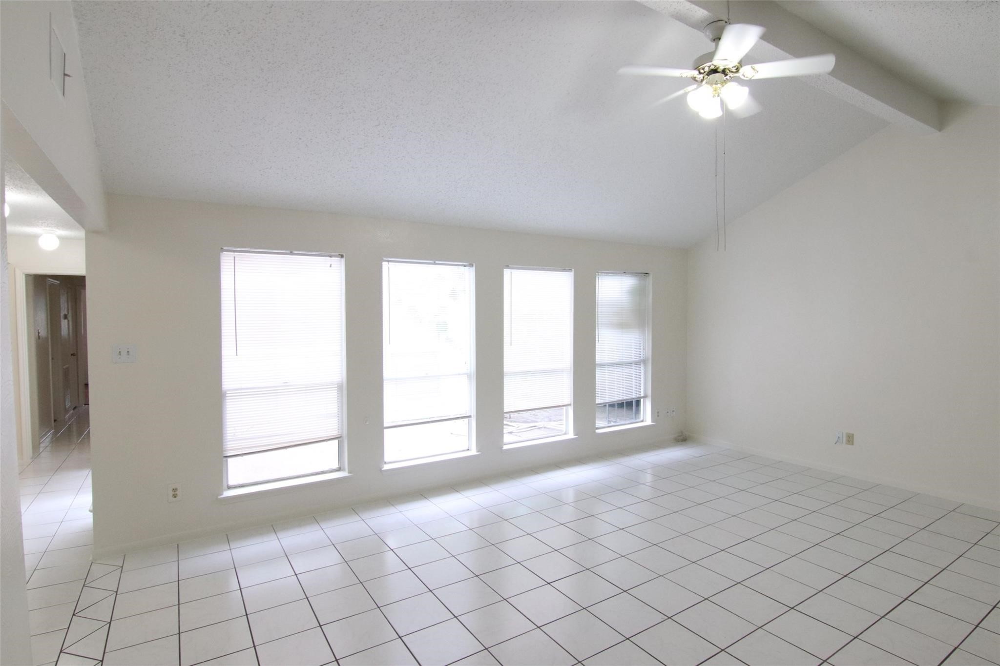 4231 Yupon Ridge Drive Houston, TX 77072 - Photo 4 of 18 a view of an empty room with window and chandelier fan