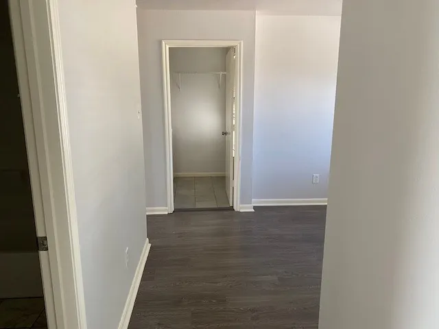 a view of a hallway with wooden floor