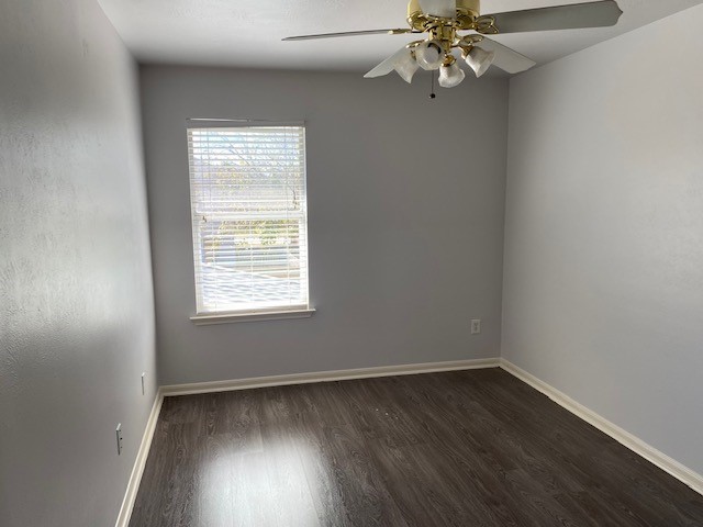 18911 Brownstone Mills Drive Cypress, TX 77433 - Photo 17 of 22 an empty room with wooden floor fan and windows