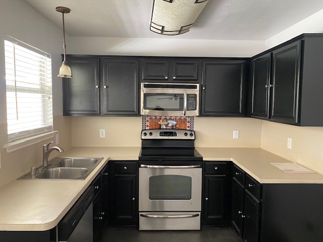 18911 Brownstone Mills Drive Cypress, TX 77433 - Photo 6 of 22 a kitchen with granite countertop a sink stove and cabinets
