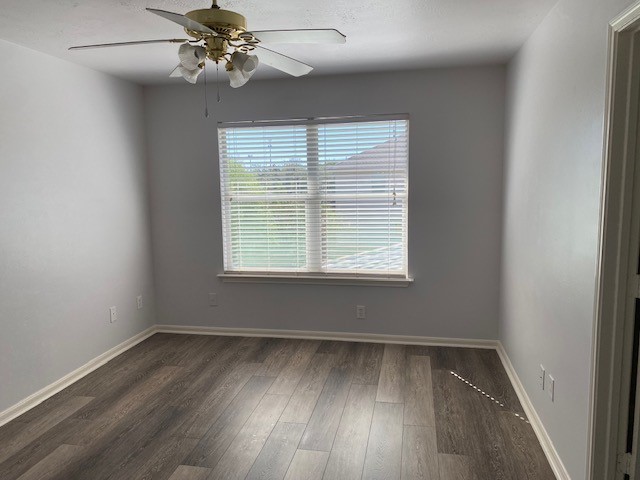 18911 Brownstone Mills Drive Cypress, TX 77433 - Photo 10 of 22 an empty room with wooden floor fan and windows